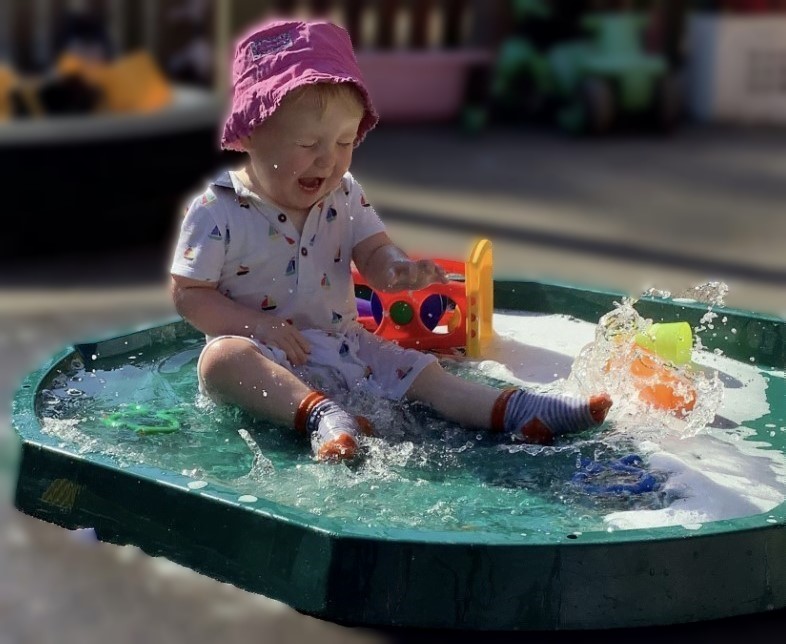 Little boy splashing in water